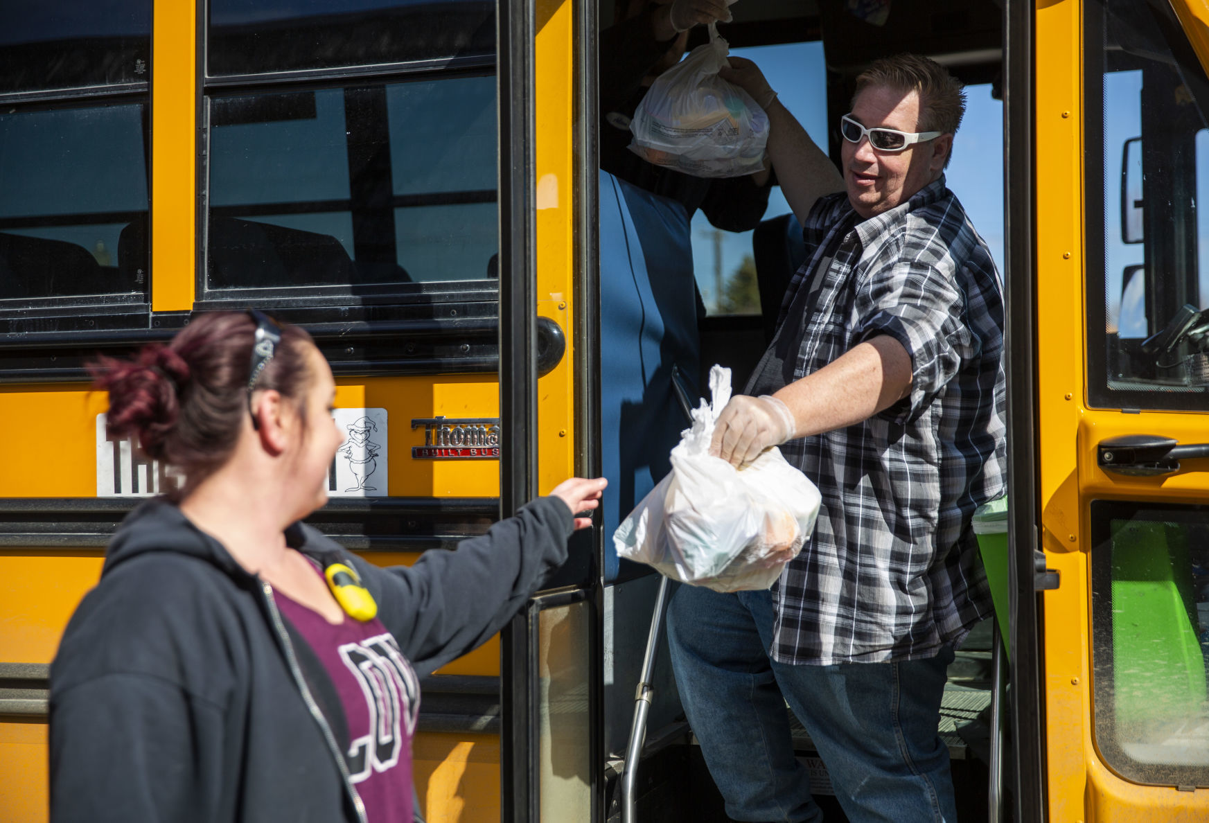 Bus drivers deliver food to students